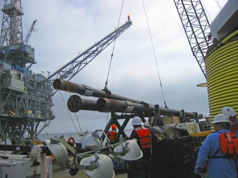 Crane lifts I-tube, a collection of conduit housed inside of a large diameter pipe, from it's cradle